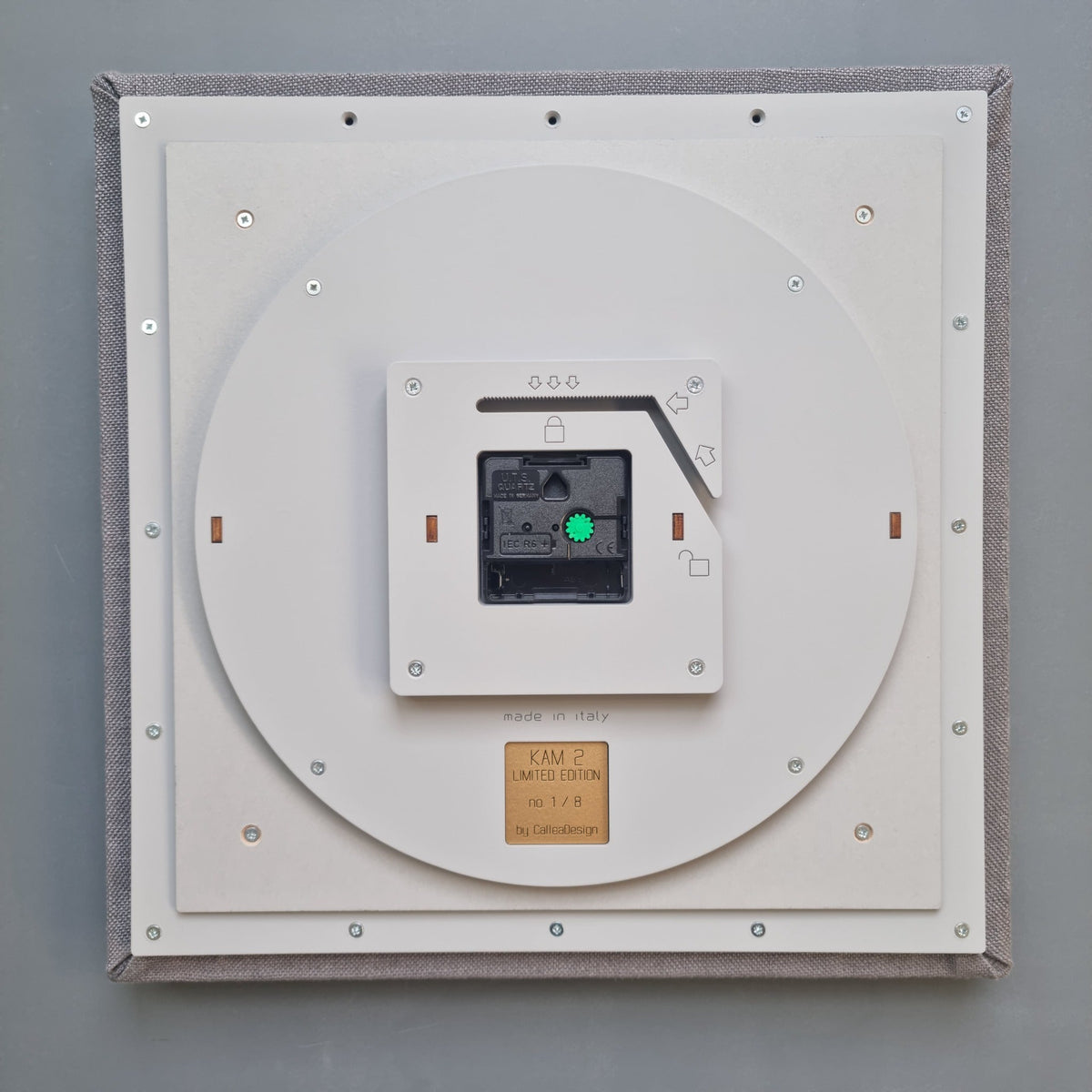 Rear view of a CalleaDesign wall clock showing the movement and mounting structure